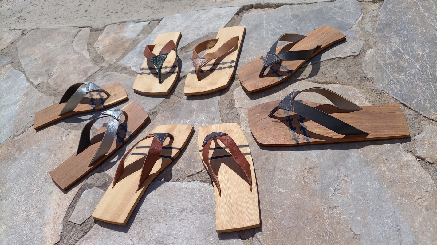 sandals, made from olive wood, with a two rubber dovetail inserts to offer flexibility and comfort while walking. The top is leather, stitched together by hand.